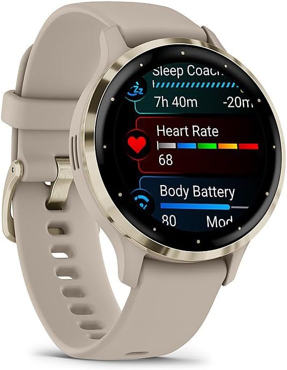A close-up of the Garmin Venu 3S smartwatch with a gold steel bezel and French gray case, displaying a heart rate reading on its bright, colorful screen, worn on a wrist.