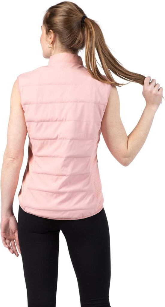 Women's Weighted Vest Review 2026: The Stylish Way to Boost Your Daily Walks A woman wearing a dusty rose, quilted, weighted vest over a casual outfit, walking outdoors on a path surrounded by greenery, smiling and looking energized.