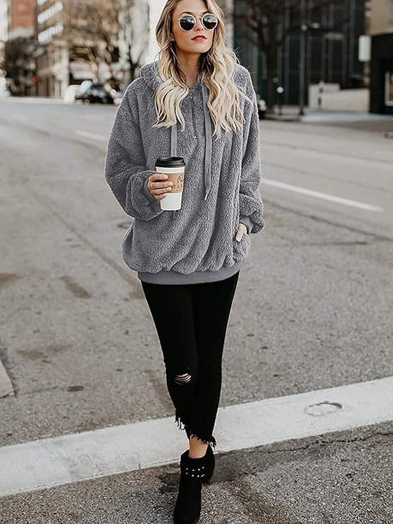 Century Star Fuzzy Hoodie Review 2026: The Ultimate Cozy Oversized Sweatshirt? A woman wearing a soft, oversized gray fuzzy hoodie with a quarter-zip closure, sitting comfortably on a couch with a warm drink, embodying relaxation and comfort.