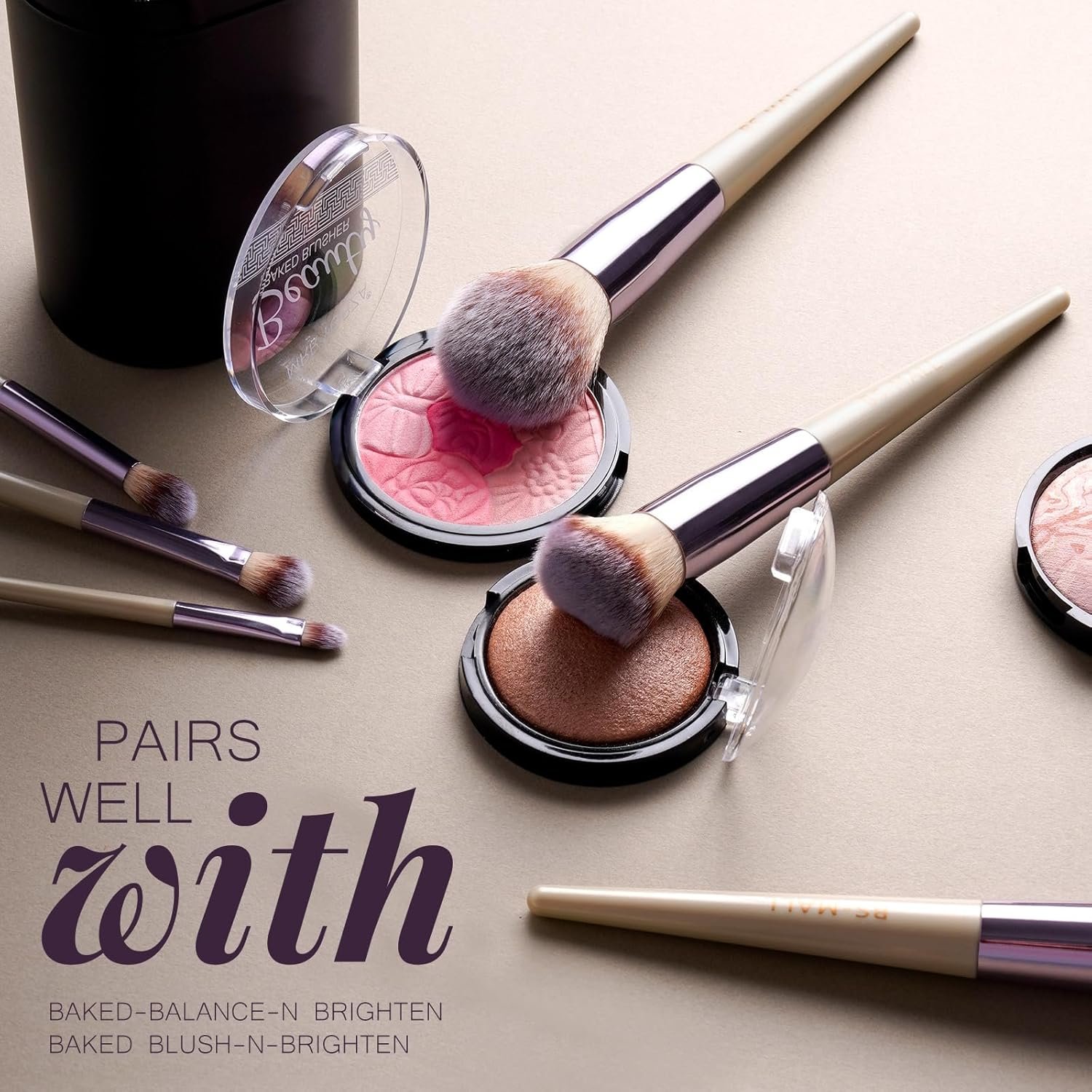 A complete set of BS-MALL pink makeup brushes is laid out on a white marble surface, showcasing the variety of foundation, eyeshadow, and blending brushes included in the kit.