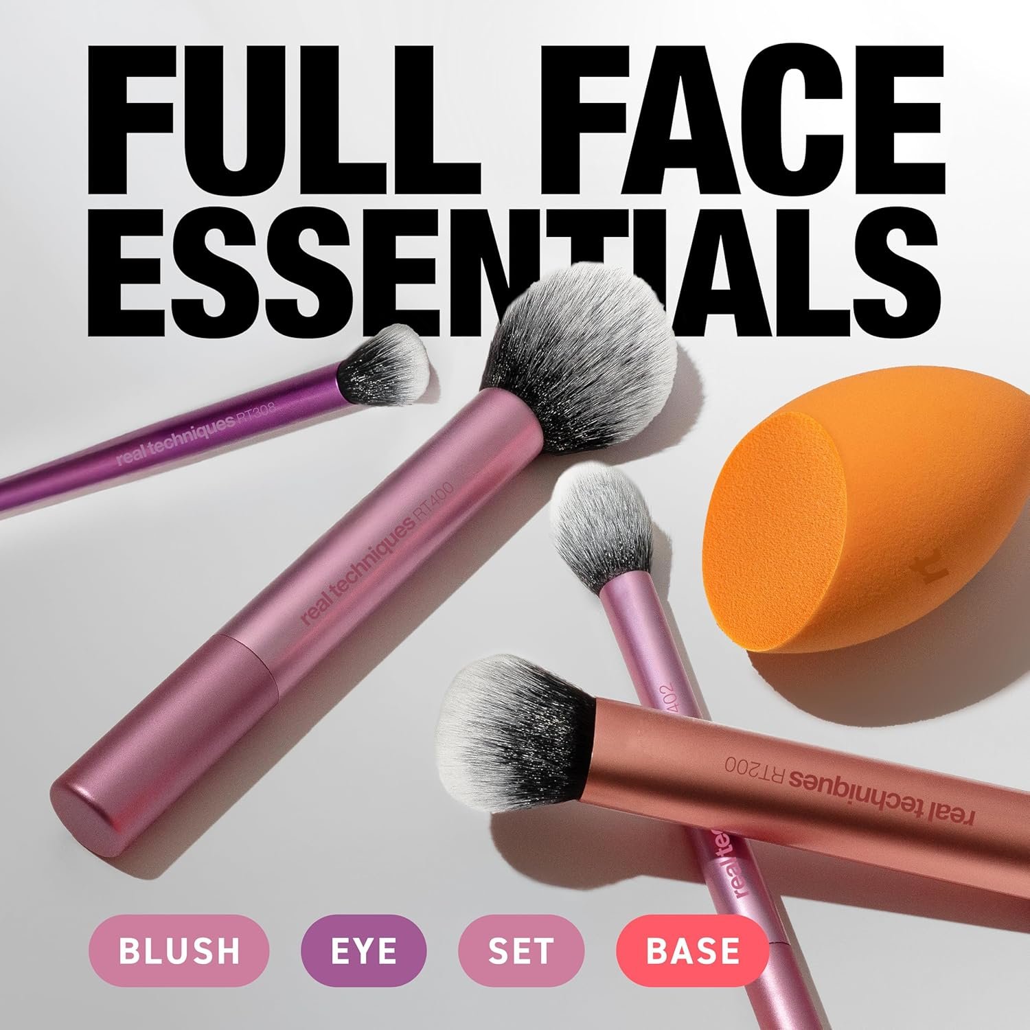 The Real Techniques A 5-piece Everyday Essentials makeup brush set laid flat, featuring four makeup brushes and one orange Miracle Complexion Sponge on a clean white background.
