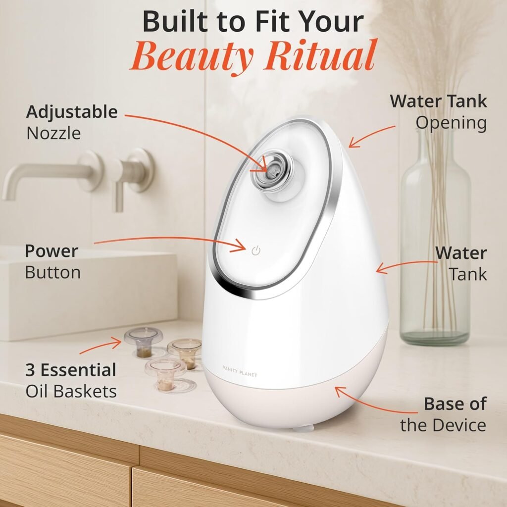 Best Facial Steamer for Deep Cleaning (At-Home Spa Guide 2026) A soft-beige Vanity Planet Aira Ionic Facial Steamer on a clean countertop, with a gentle mist rising from the adjustable nozzle, surrounded by a towel and skincare products.